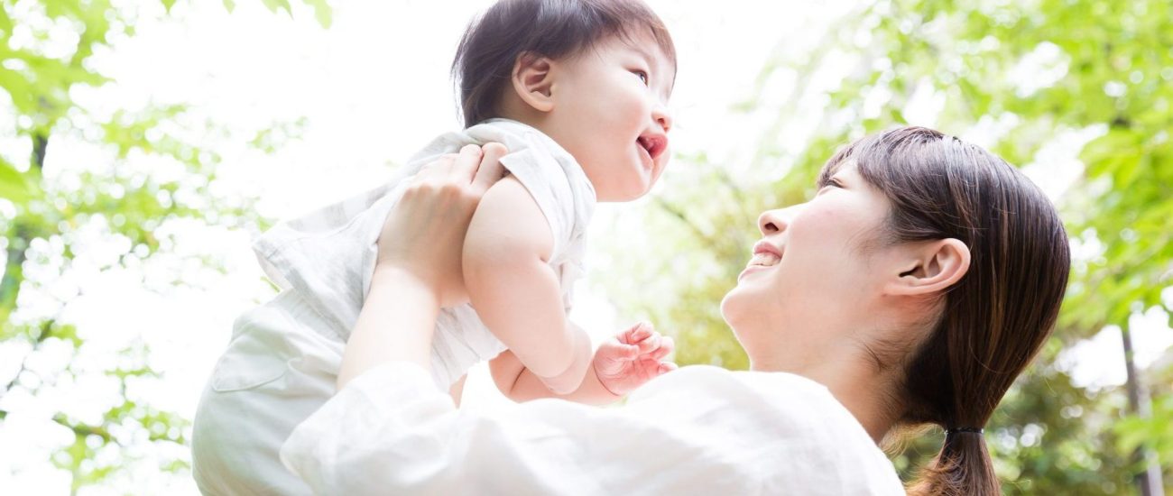 asian mother and baby in park
