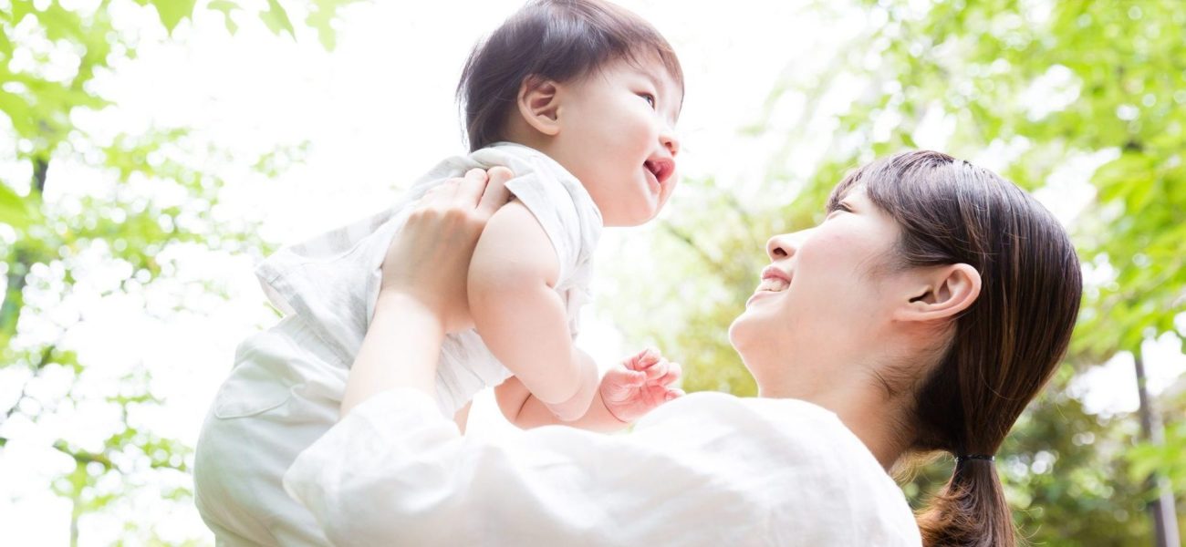 asian mother and baby in park